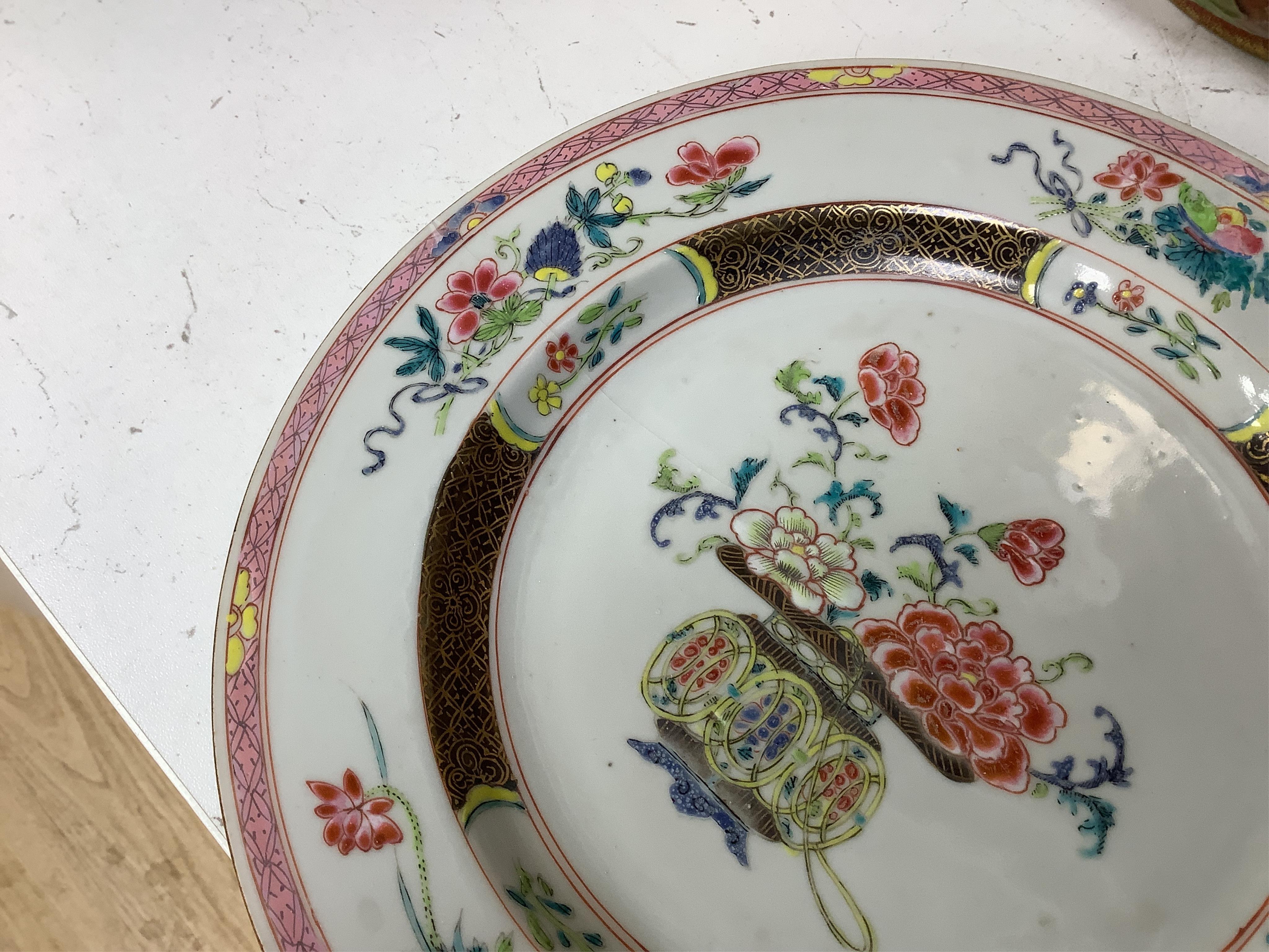 A Chinese iron-red ‘sanduo’ dish, 19th century and a Chinese famille rose plate, Yongzheng. famille rose plate 22.5cm diameter. Condition - poor to fair